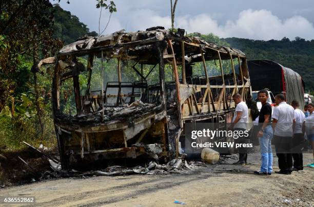 People stand next to a bus attacked by members of the National Liberation Army near Tutunendo Choco, according to local media, December 22, 2016 in...