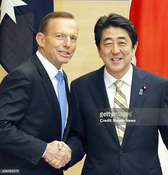 Japan - Australian Prime Minister Tony Abbott and Japanese Prime Minister Shinzo Abe shake hands ahead of a special meeting of the National Security...