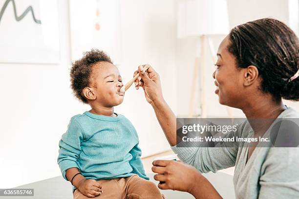 toddler eating breakfast - spoon feeding stock pictures, royalty-free photos & images