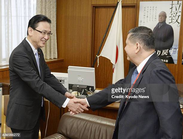 Japan - Marzuki Darusman , the U.N. Special rapporteur on human rights in North Korea, shakes hands with Keiji Furuya, Japan's state minister in...