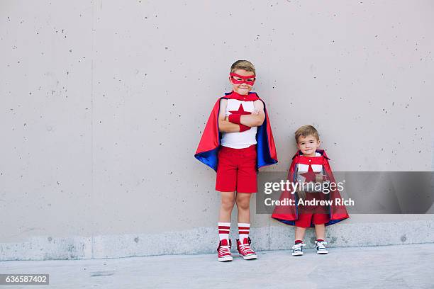 two young boy superheroes imagine taking off - baby superhero stock pictures, royalty-free photos & images