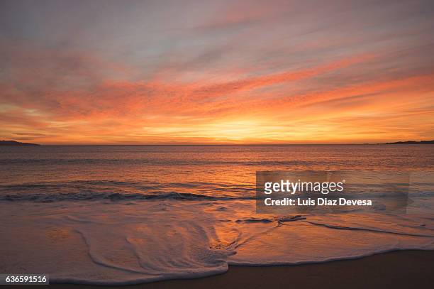 sunset over the beach - sunset beach stockfoto's en -beelden