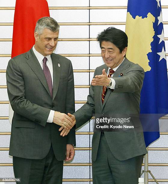 Japan - Kosovo Prime Minister Hashim Thaci shakes hands with his Japanese counterpart, Shinzo Abe, ahead of talks at Abe's office in Tokyo on April...