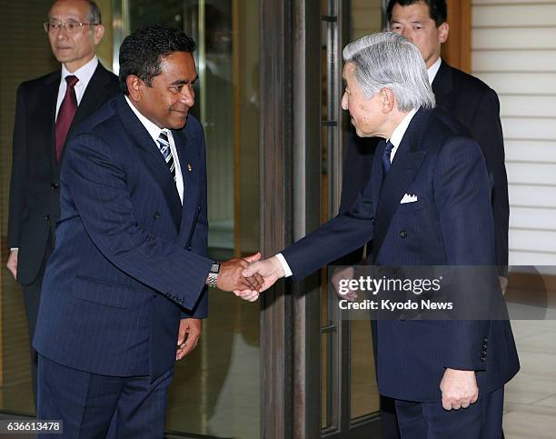 Japan - Maldives President Abdulla Yameen and Japan's Emperor Akihito shake hands after their meeting at the Imperial Palace in Tokyo on April 15,...