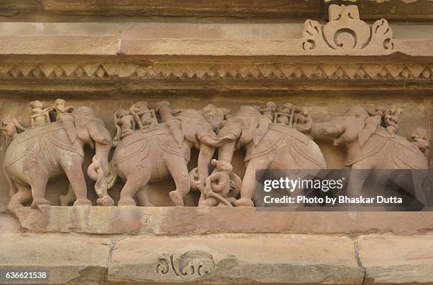 sculptures at the plinth of parshwanath temple, khajuraho - khajuraho statues stock pictures, royalty-free photos & images