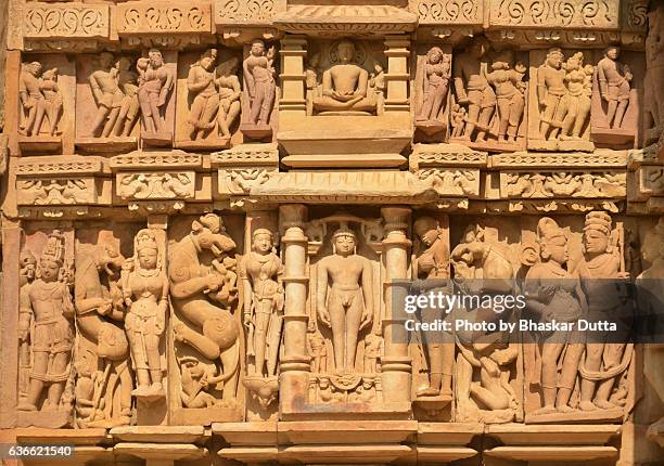 sculptures at the walls of parshwanath temple, khajuraho - khajuraho statues stock pictures, royalty-free photos & images