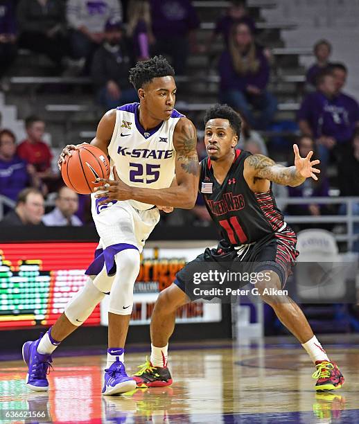 Guard Wesley Iwundu of the Kansas State Wildcats drives around guard David Efianayi of the Gardner-Webb Bulldogs during the first half on December...