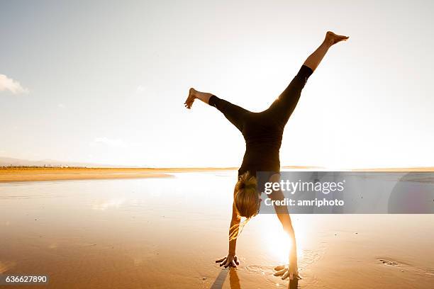 cartwheel sunset beach - cartwheel stock pictures, royalty-free photos & images
