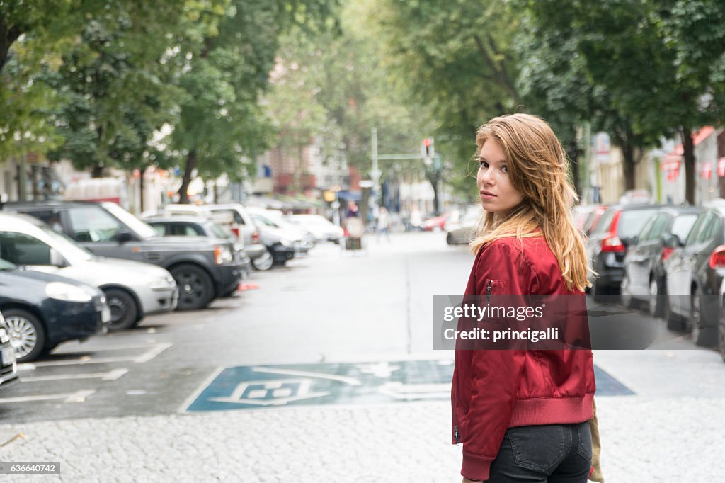 Femme marchant dans la rue en regardant en arrière