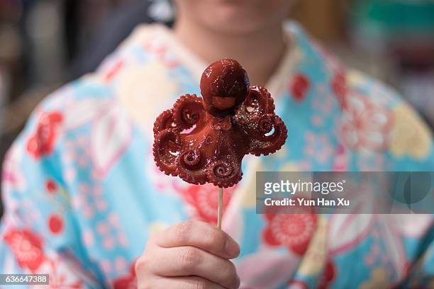 close-up of baby octopus on sticks - food tourism stock pictures, royalty-free photos & images