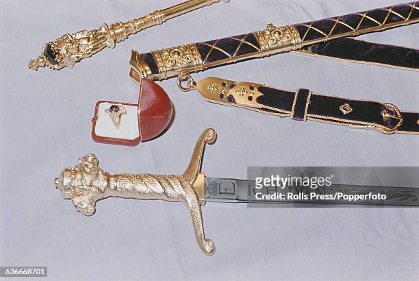 View of the Prince of Wales's ceremonial investiture sword etched with the motto 'Ich Dien' along with the velvet covered scabbard and belt, golden...