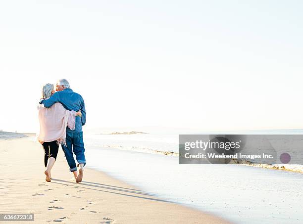 best way to spend vacations - couple at beach sunny stock pictures, royalty-free photos & images