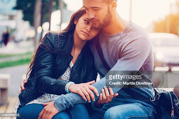 young man consoling his girlfriend - apologize stockfoto's en -beelden