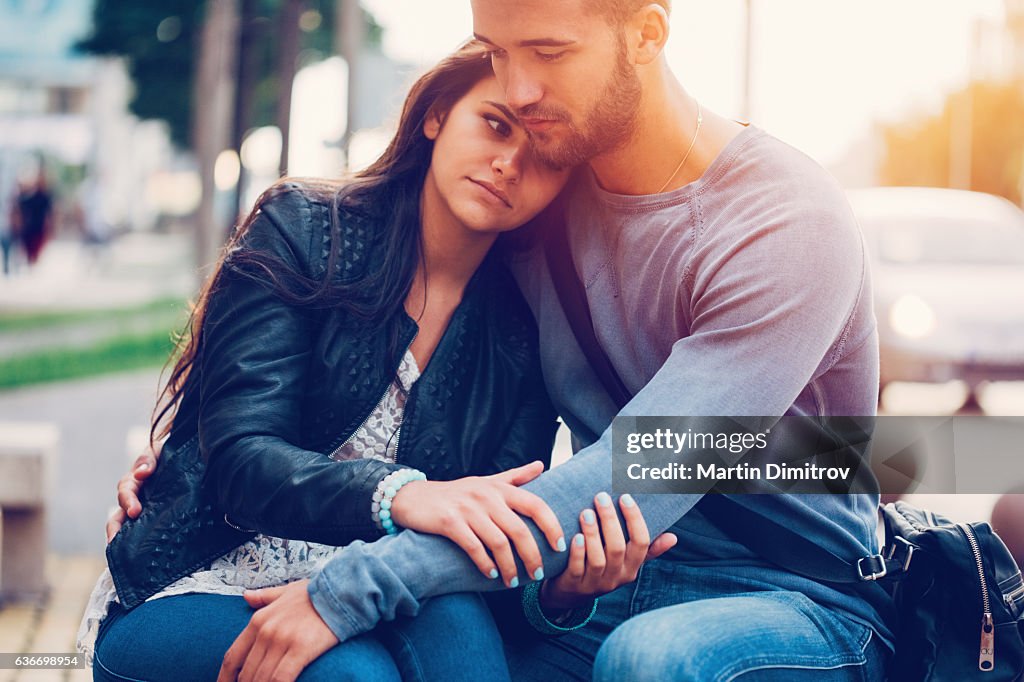 Young man consoling his girlfriend