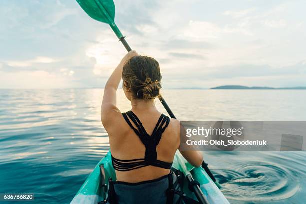 woman kayaking in the sea - one piece swimsuit stock pictures, royalty-free photos & images
