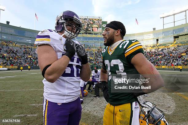 Chad Greenway of the Minnesota Vikings and Micah Hyde of the Green Bay Packers meet after the Green Bay Packers beat the Minnesota Vikings 38-25 at...
