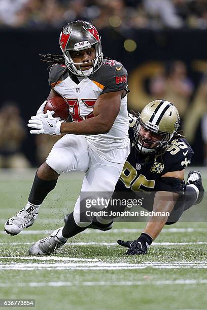 Jacquizz Rodgers of the Tampa Bay Buccaneers runs past Tyeler Davison of the New Orleans Saints during a game at the Mercedes-Benz Superdome on...