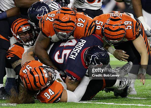 Jay Prosch of the Houston Texans is tackled by Domata Peko of the Cincinnati Bengals, Rey Maualuga,Nick Vigil and Pat Sims at NRG Stadium on December...