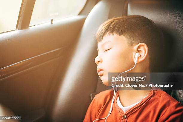 the boy listened to music with headphones. - young boy enjoying music stock-fotos und bilder