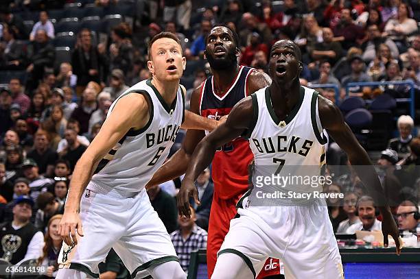 Steve Novak and Thon Maker of the Milwaukee Bucks block out Daniel Ochefu of the Washington Wizards during the second half of a game at the BMO...