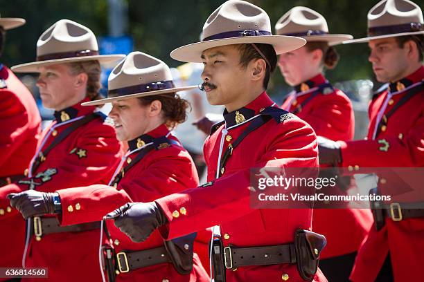 rcmp marching in canada day parade. - mountie stock pictures, royalty-free photos & images