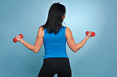 Fitness woman working out with dumbbells.