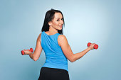 Fitness woman working out with dumbbells.
