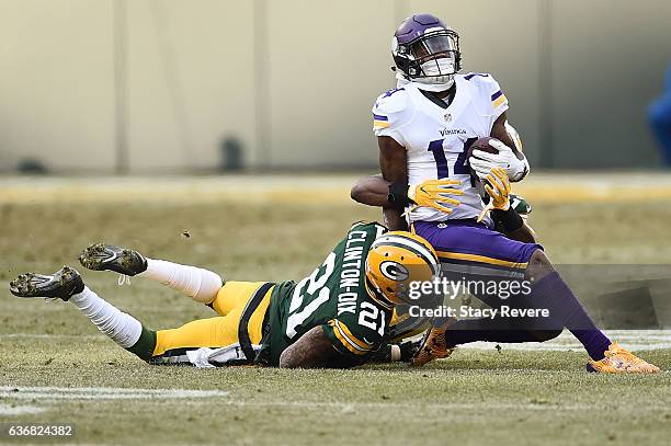 Stefon Diggs of the Minnesota Vikings is brought down by Kentrell Brice and Ha Ha Clinton-Dix of the Green Bay Packers during a game at Lambeau Field...