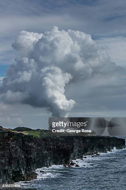 Steam rises from the ocean entry, a dramatic point where active flowing lava meets the Pacific Ocean, on December 12 at Volcanoes National Park,...