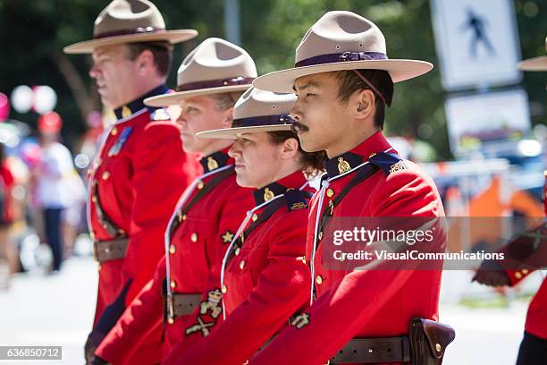 rcmp marching in canada day parade. - mountie stock pictures, royalty-free photos & images