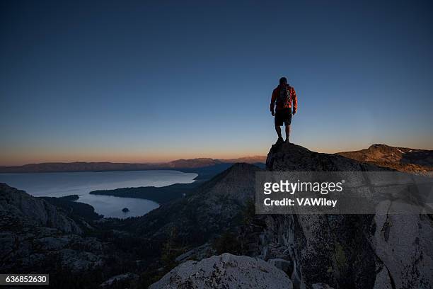 man summiting a beautiful mountain top in lake tahoe - emerald bay lake tahoe bildbanksfoton och bilder