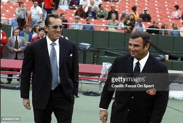 Head Coach Hank Stram of the Kansas City Chiefs and Al Davis owner of the Oakland Raiders looks on prior to the start of an NFL football game circa...