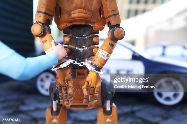 arrested robot with handcuffs - crime stock illustrations