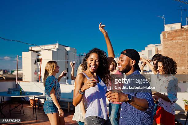happy friends dancing and drinking wine at rooftop party - hot spanish women stock pictures, royalty-free photos & images