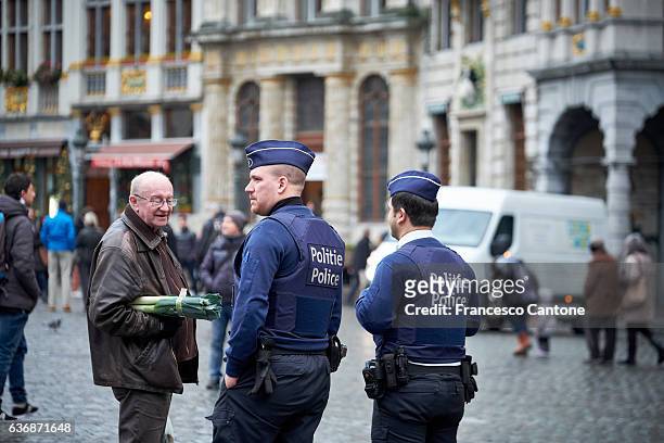 policemen control a public place in the belgian capital city - belgium police stock pictures, royalty-free photos & images