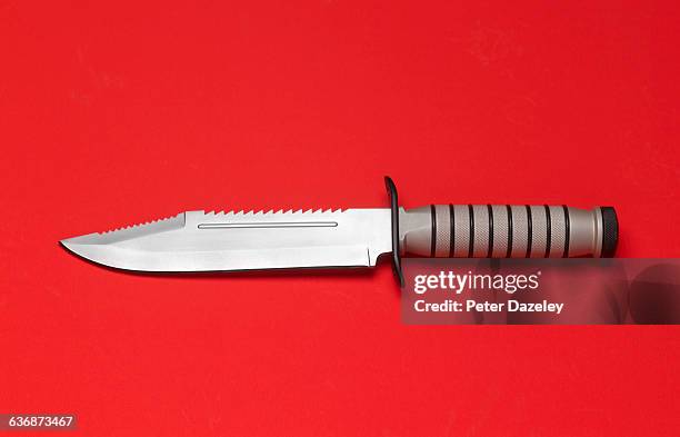 knife on red background - messerstecherei stock-fotos und bilder