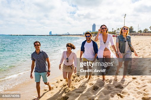 Friends Messin Around Group Of Friends Having Fun Messing Around On The Beach High-Res Stock ...