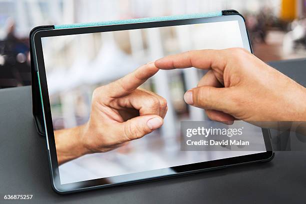 fingers touching  over a tablet computer. - touchpad stock-fotos und bilder