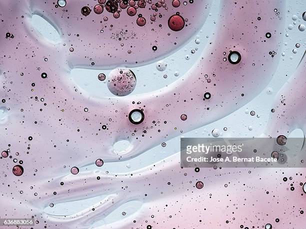 full frame of the textures formed by the bubbles of oil in the shape of circle floating on the water color blue - base sports equipment stockfoto's en -beelden