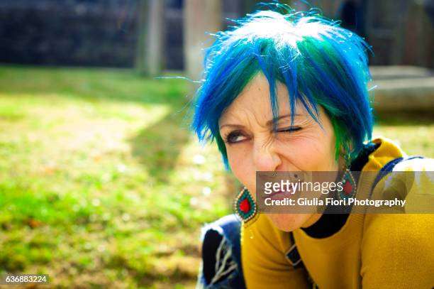 young woman with bright blue hair - earring stud stock pictures, royalty-free photos & images