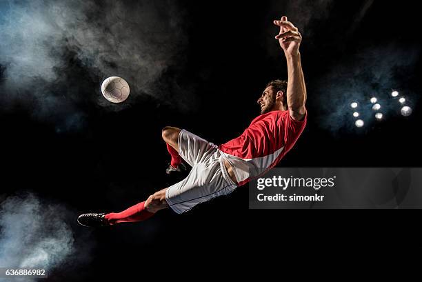 soccer player kicking - ball pit stockfoto's en -beelden