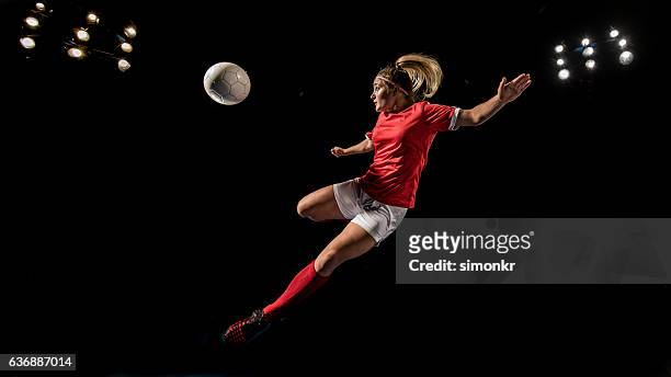 soccer player kicking - football player stock pictures, royalty-free photos & images