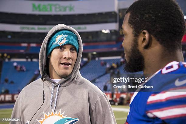 Ryan Tannehill of the Miami Dolphins speaks with Charles Clay of the Buffalo Bills after the game on December 24, 2016 at New Era Field in Orchard...