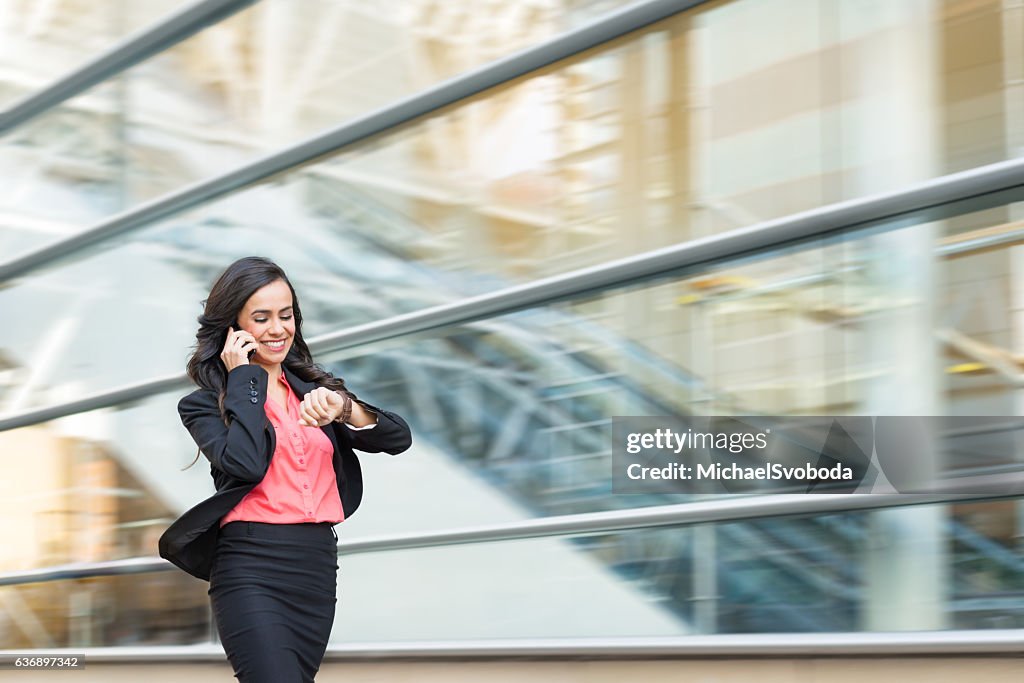 Hispanic Business Women On Phone Walking In A Rush