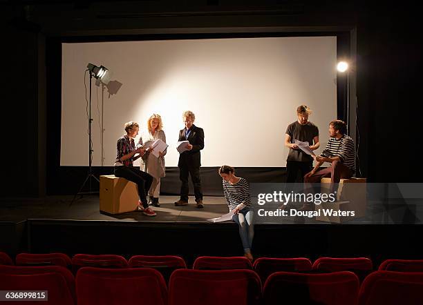 community theatre group learning script on stage. - director foto e immagini stock