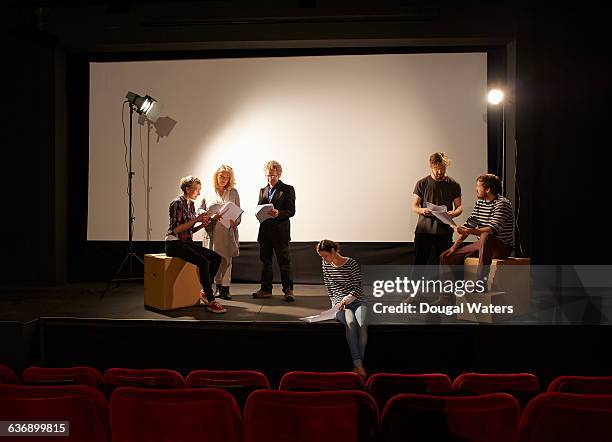 community theatre group learning script on stage. - actress rehearsing stock pictures, royalty-free photos & images