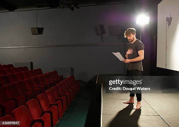 actor rehearsing his lines on stage. - faire du théâtre photos et images de collection