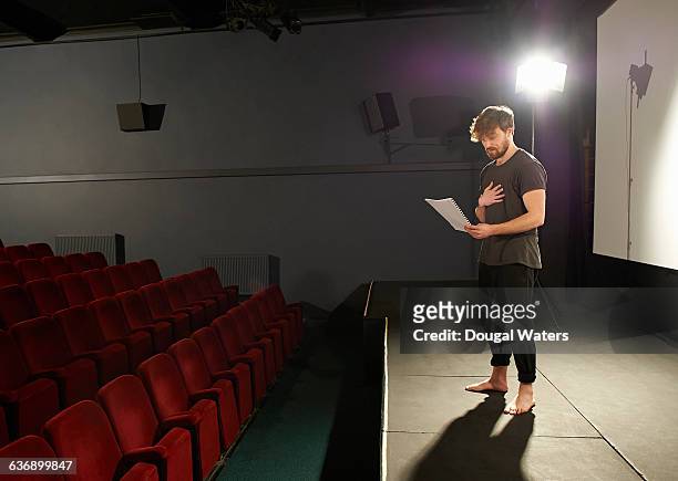 actor rehearsing his lines on stage. - attore foto e immagini stock