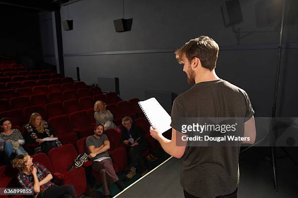 actor performing on stage to small audience. - attore foto e immagini stock