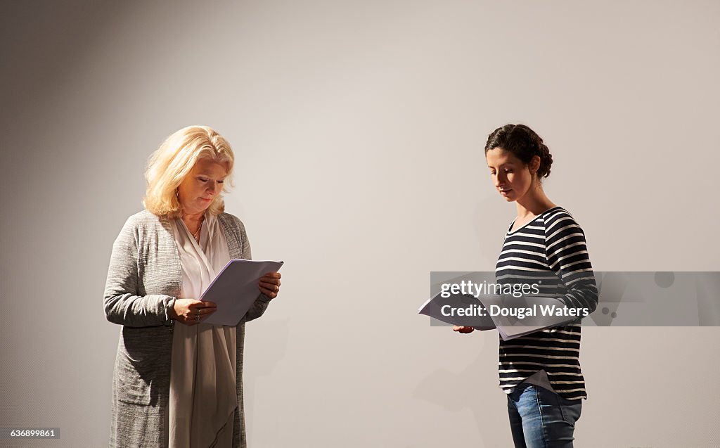 Two actresses rehearsing script.